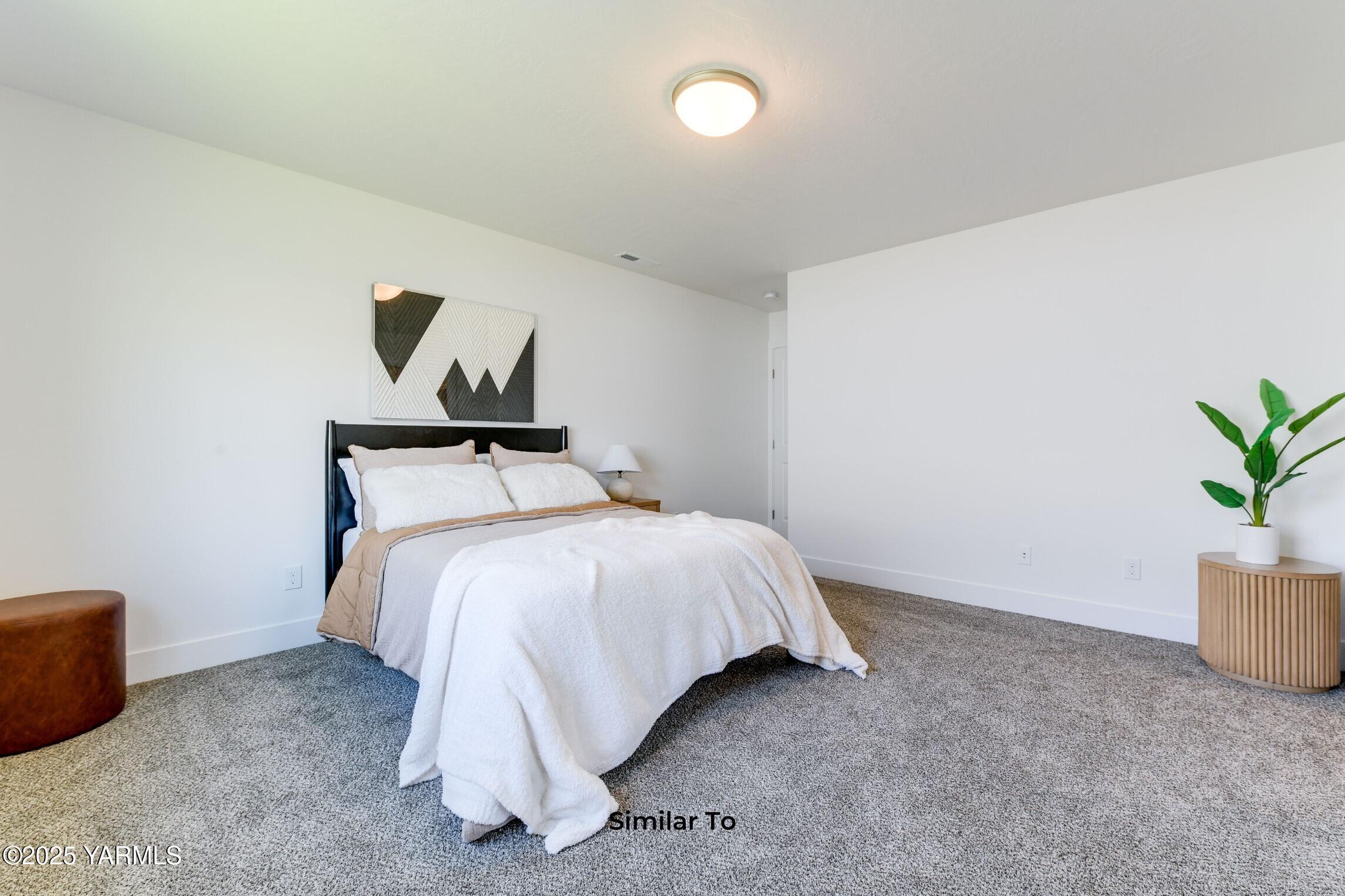 506 Grapevine Street, Unit PHASE 3 LOT 11) SPEC Grandview, WA 98930 - Photo 18 of 22 a bed room with a bed and a chair