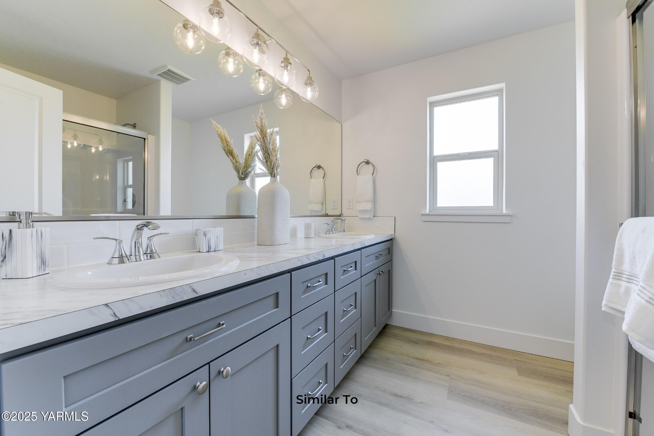 506 Grapevine Street, Unit PHASE 3 LOT 11) SPEC Grandview, WA 98930 - Photo 19 of 22 a bathroom with double sink and a mirror
