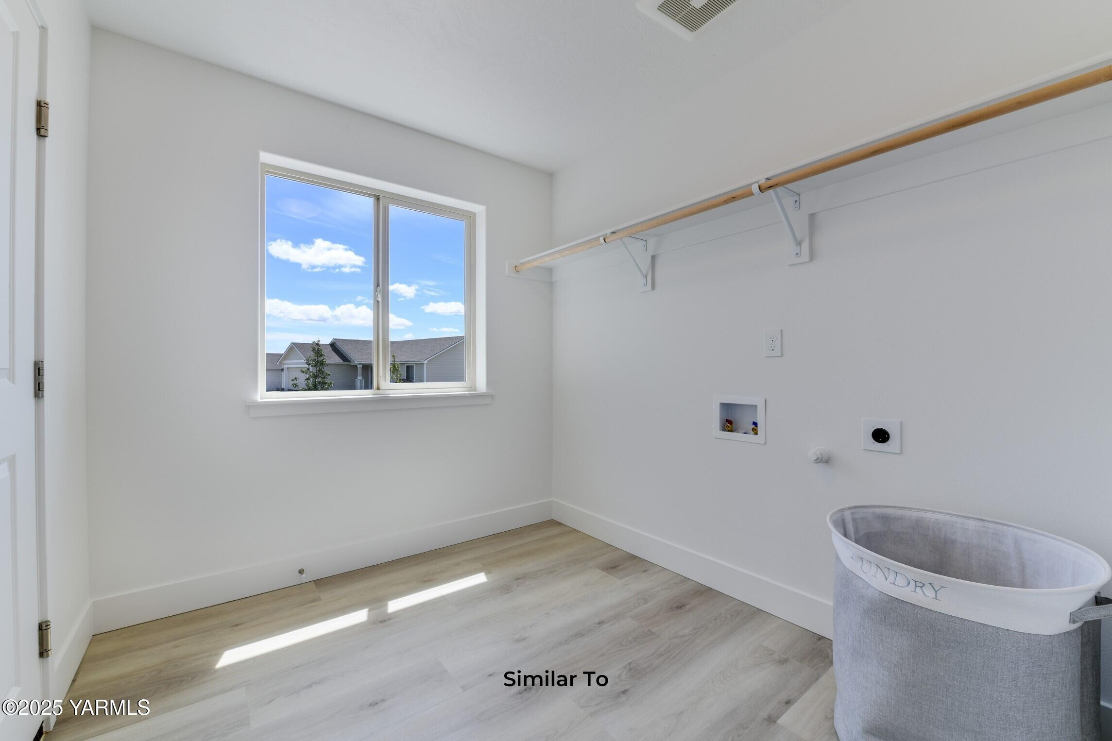 506 Grapevine Street, Unit PHASE 3 LOT 11) SPEC Grandview, WA 98930 - Photo 21 of 22 a view of a room with wooden floor and window