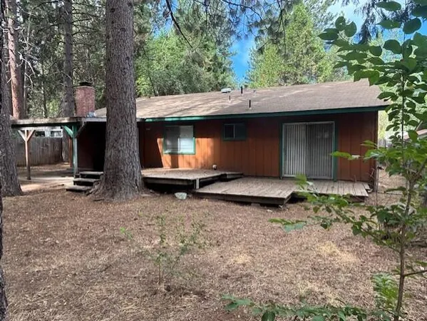 a backyard of a house with barbeque oven fire pit table and chairs