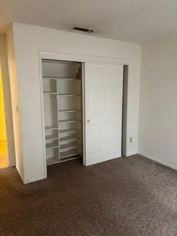 a view of an empty room and closet