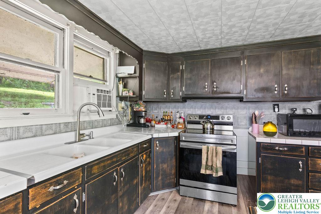 1644 Moselem Spring Road Hamburg, PA 19526 - Photo 10 of 24 a kitchen with a sink a stove and cabinets