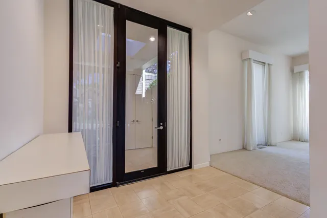 a view of an empty room with a fireplace and a window