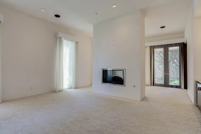 a view of an empty room with glass windows