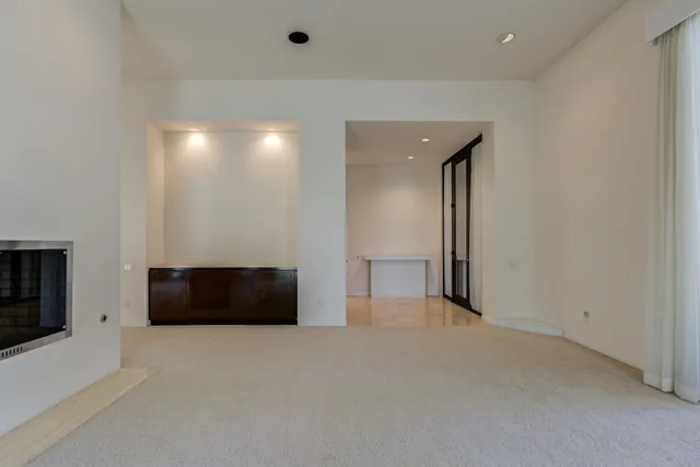 a living room with furniture and large windows