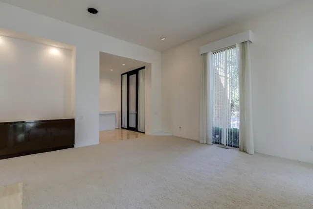 a living room with furniture large window and flat screen tv
