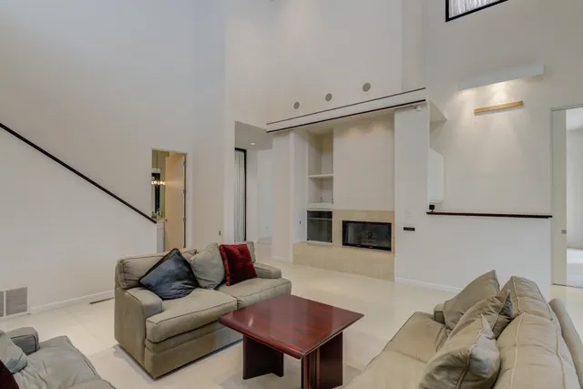 a kitchen with white cabinets and white appliances