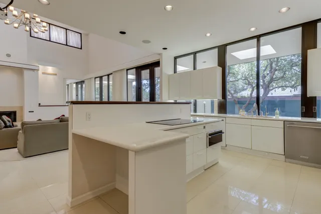 a view of a house with backyard and a tree