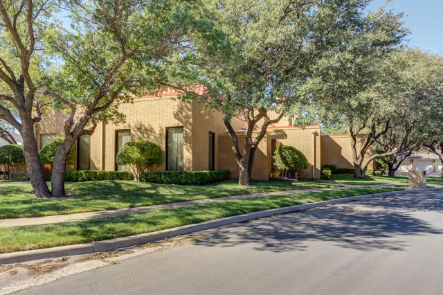 an empty room with a fireplace and window