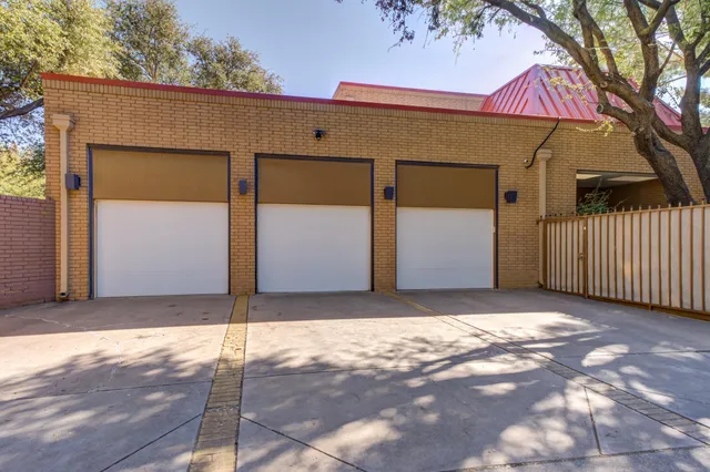 an empty room with windows and fireplace