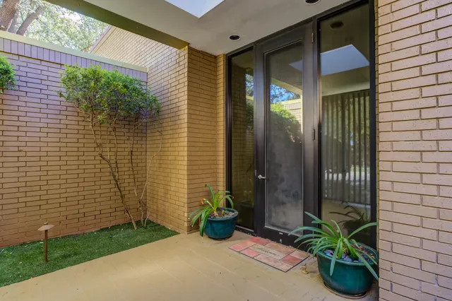 a view of an empty room with windows and a balcony