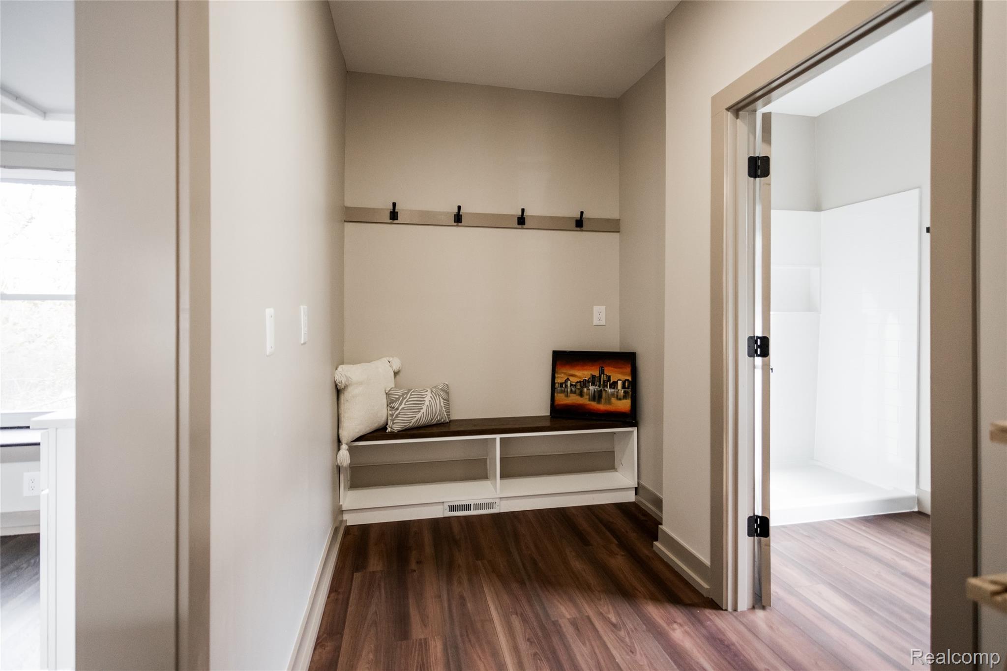 2630 Harding Street Detroit, MI 48214 - Photo 12 of 30 Entryway featuring wood-finish flooring, a built-in bench with integrated shelving, and wall-mounted coat hooks