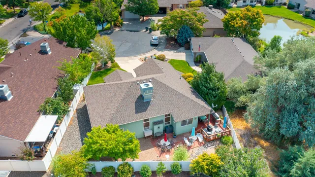 an aerial view of a house with garden space and swimming pool