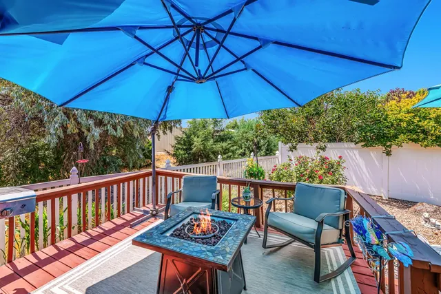 a view of balcony with chairs and umbrella