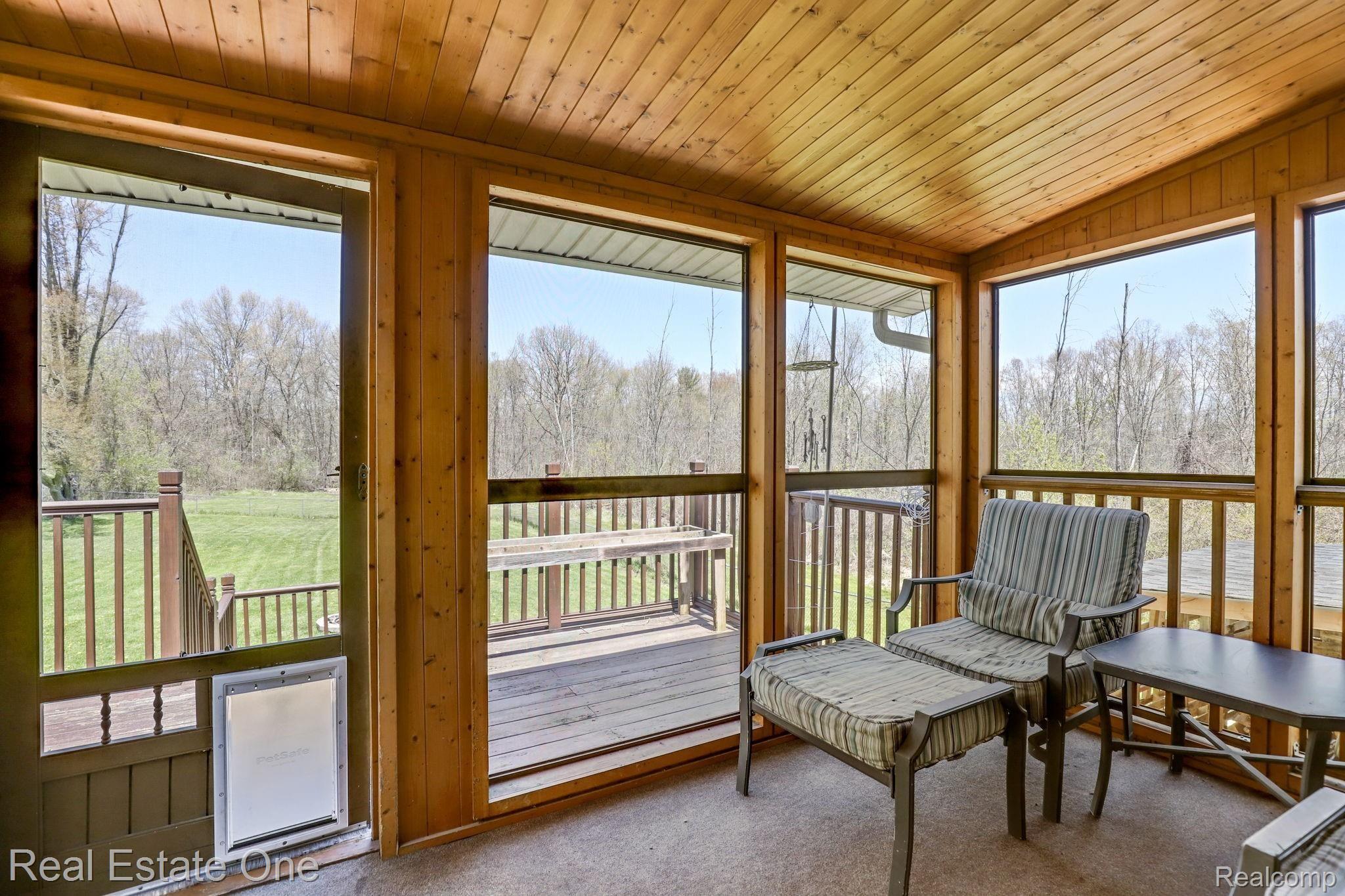 6645 Dunn Road Howell, MI 48855 - Photo 38 of 47 Screened Porch leading to a deck