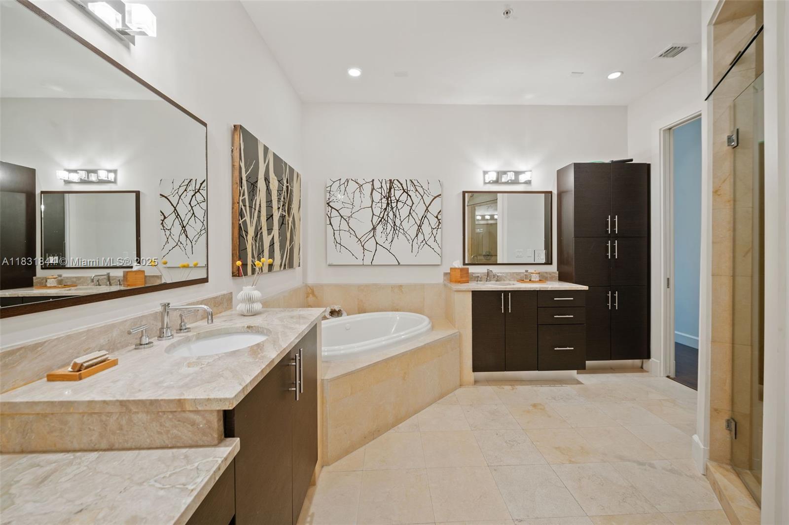 7560 Southwest 56th Court Miami, FL 33143 - Photo 30 of 60 a bathroom with a sink double vanity and a bathtub