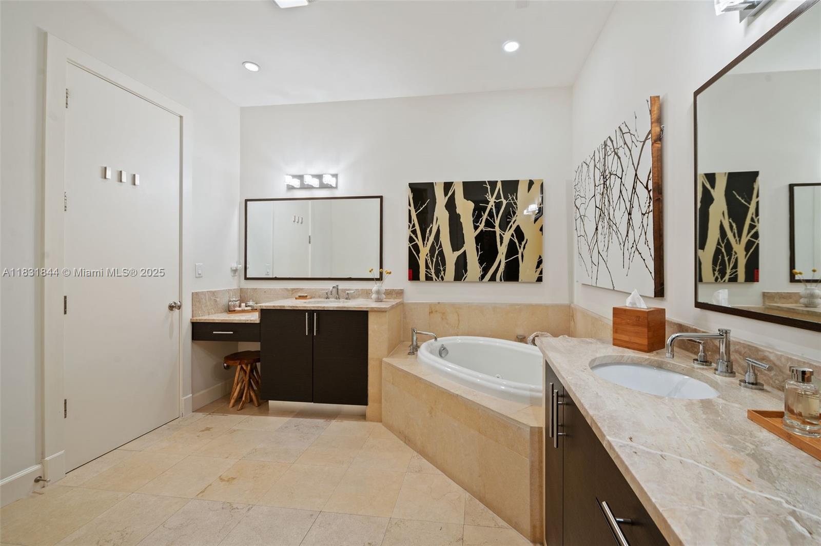 7560 Southwest 56th Court Miami, FL 33143 - Photo 31 of 60 a bathroom with a granite countertop sink a mirror and a bathtub