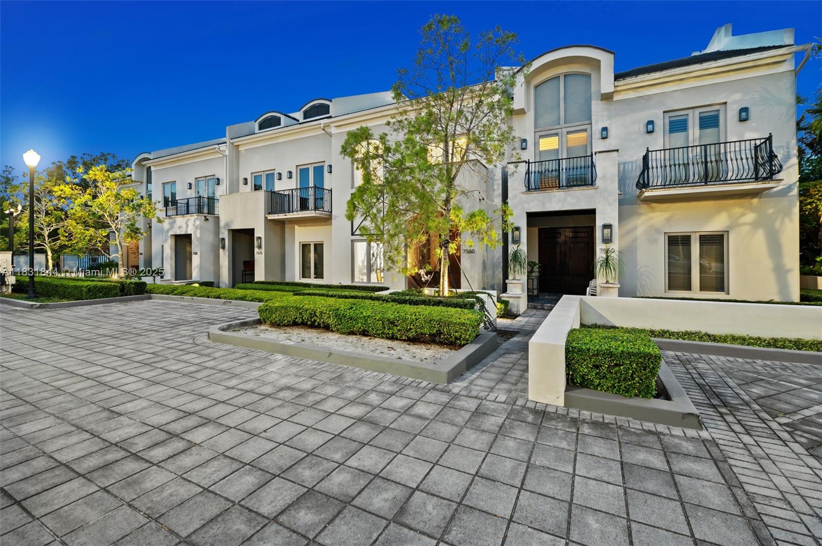 7560 Southwest 56th Court Miami, FL 33143 - Photo 46 of 60 a front view of a building with garden