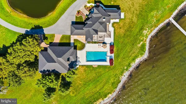 a living room with furniture and floor to ceiling windows