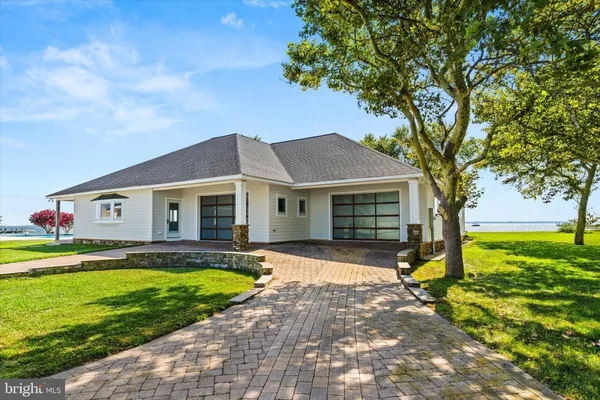 a living room with furniture a fireplace and a floor to ceiling window