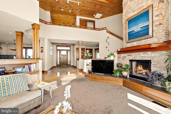 a kitchen with stainless steel appliances granite countertop a refrigerator a stove a sink dishwasher and white cabinets with wooden floor