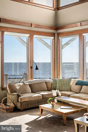 a spacious bedroom with a bed and glass walk in closet