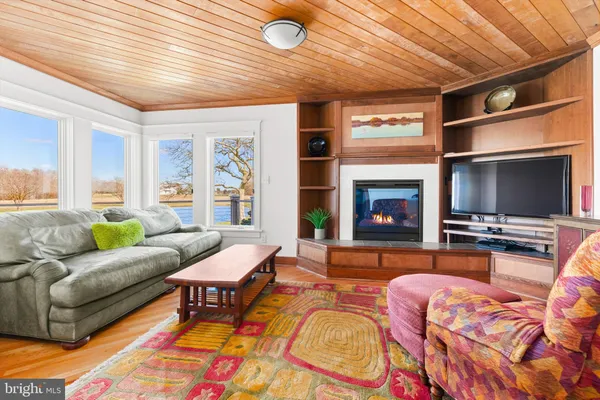 a room with furniture pool table flat screen tv and window