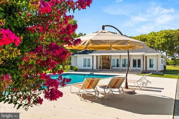 a view of a swimming pool with a yard