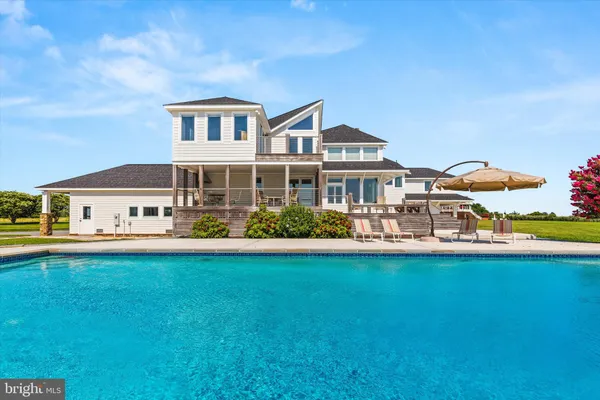 a view of an entryway with wooden floor and a livingroom