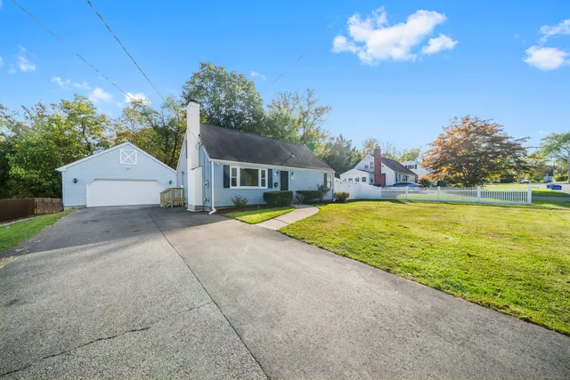 a view of a house with swimming pool and a yard