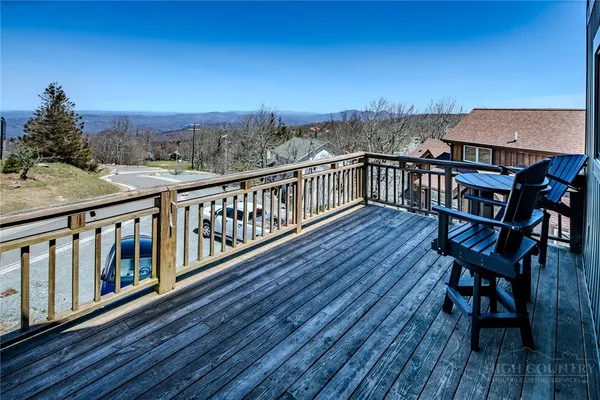 a bedroom with a bed a couch and a window