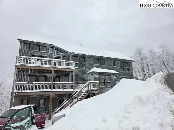 a view of balcony with wooden floor and mountain view