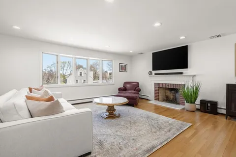 a living room with furniture fireplace and a flat screen tv