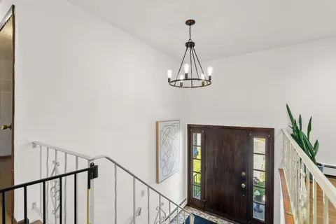 a view of a hallway view with chandelier