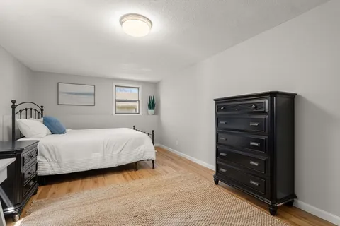 a bedroom with a bed and a dresser