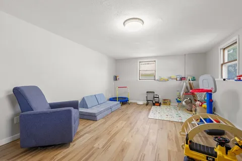 a bedroom with furniture and a wooden floor