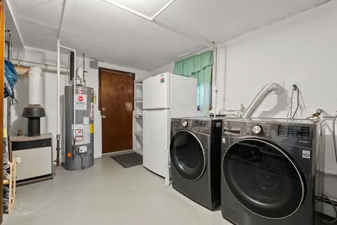 a view of a storage & utility room with closet washing machine