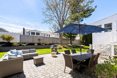 a view of an outdoor sitting area with furniture and umbrella