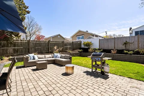 a view of a patio with couches chairs and swimming pool