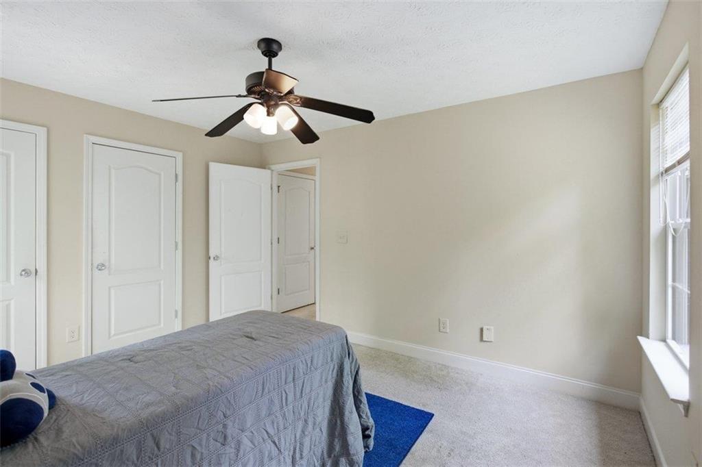 1231 Hillview Road Hampton, GA 30228 - Photo 23 of 49 a bedroom with a bed and a chandelier
