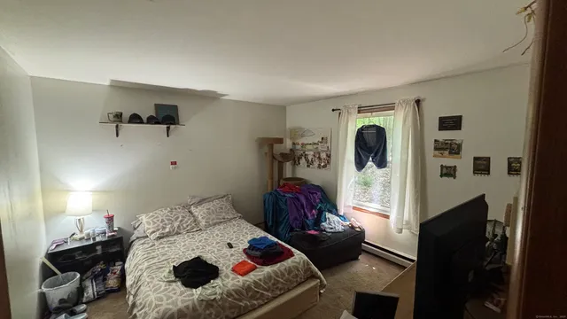 a bedroom with a bed and a mirror