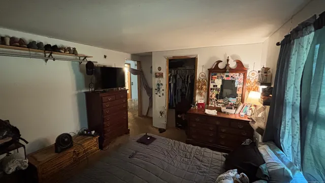 a bed room with a bed and a mirror