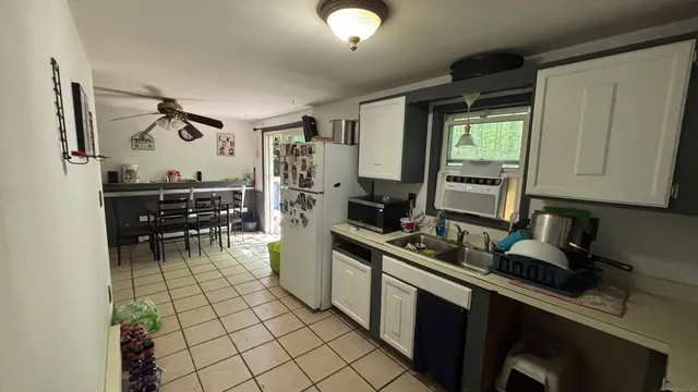 a kitchen with stainless steel appliances a sink stove and cabinets