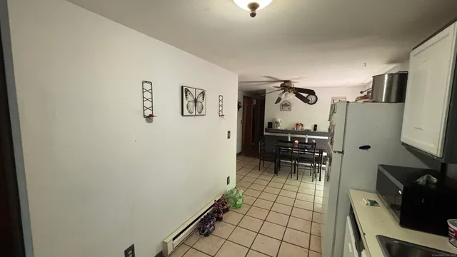 a view of a hallway with workspace and a window