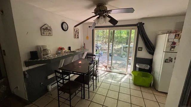 a dining room with furniture and a window