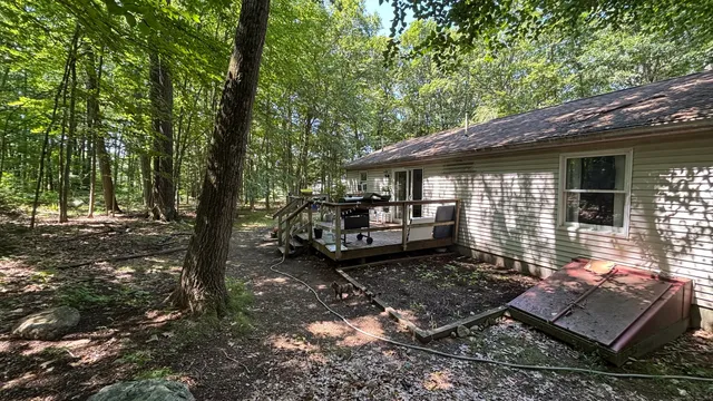 a view of a patio with table and chairs with wooden fence and floor