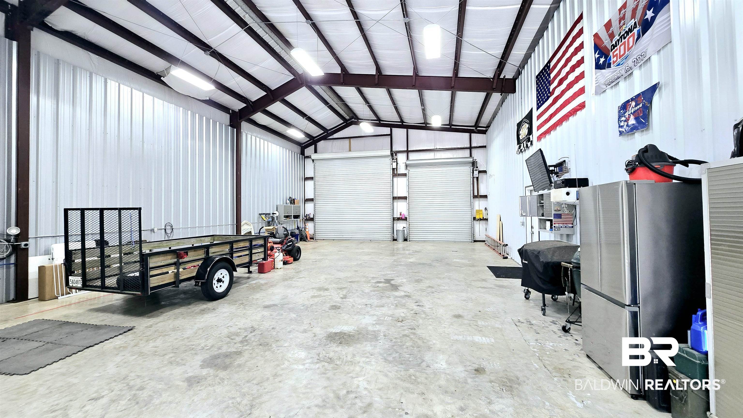 12437 Charlie Head Road Stapleton, AL 36578 - Photo 23 of 35 Garage with freestanding refrigerator and metal wall