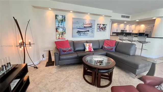 a living room with furniture a rug and white walls