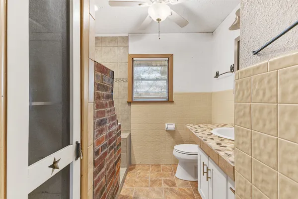 a bathroom with a toilet a sink and shower