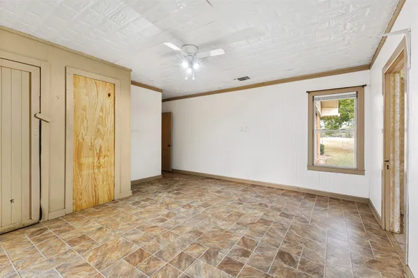an empty room with windows and closet